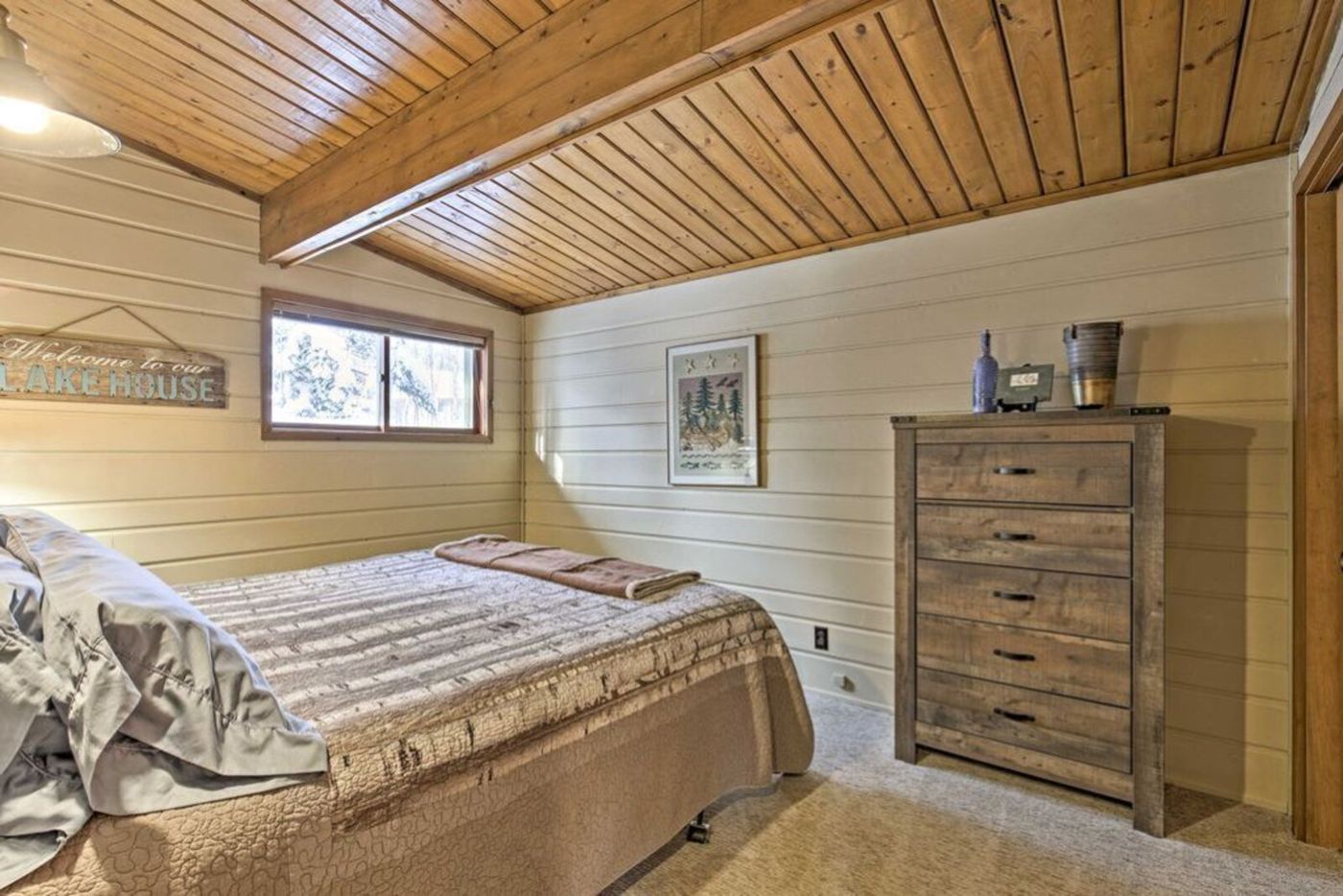Bedroom with dresser and wood ceiling