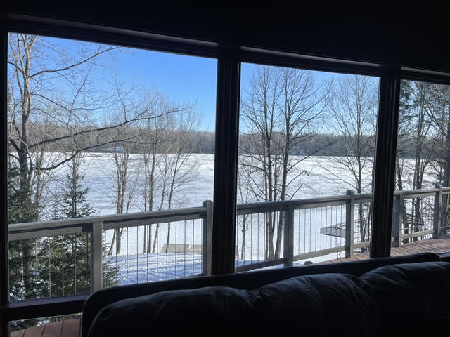 Frozen, snowy lake seen through the living-room windows